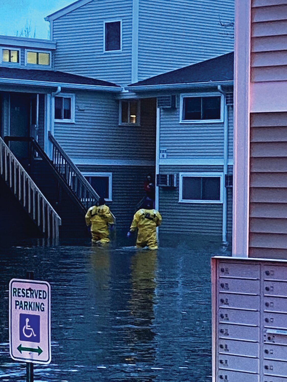 CARRYING THE RESIDENTS OUT: Johnston firefighters carried residents out of a Park Street apartment complex following flooding last week.